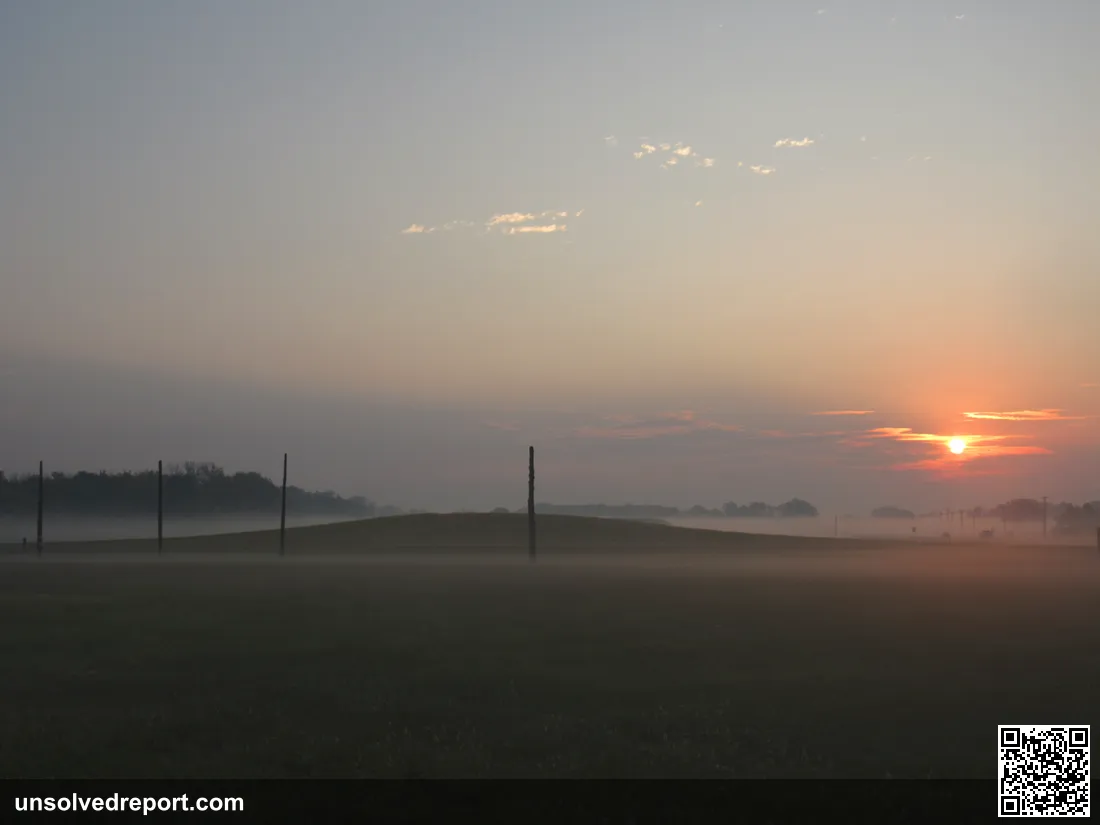A section of the reconstructed Cahokia Woodhenge at dawn. Mound 44 in immediate background.