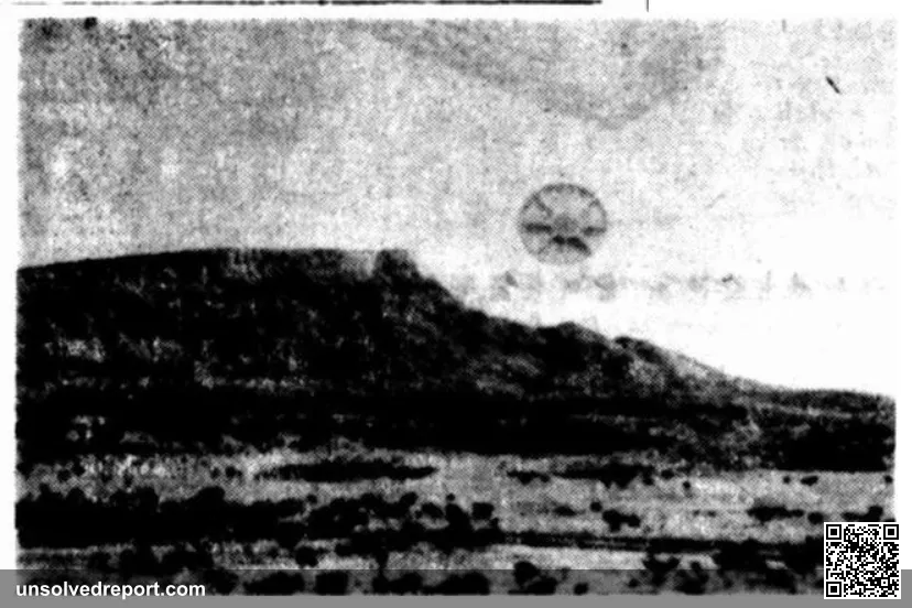 Grainy black and white newspaper photograph purportedly showing a disc-shaped UFO over a hillside landscape, published in the Centralian Advocate Australian newspaper in 1954